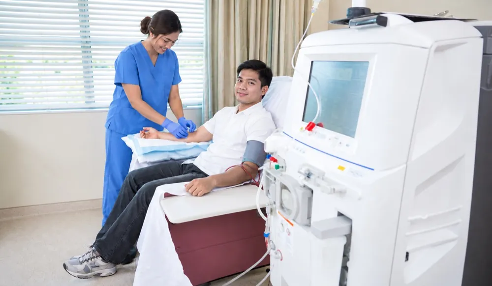 Nurse preparing a patient for hemodialysis